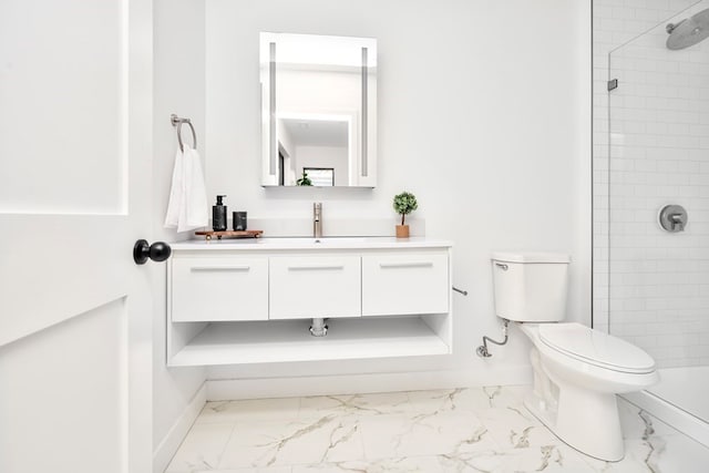 bathroom featuring tile patterned floors, a tile shower, vanity, and toilet