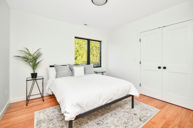 bedroom featuring light hardwood / wood-style flooring and a closet