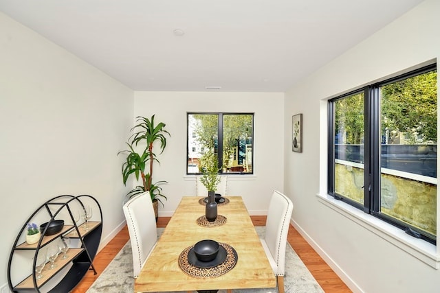 dining space with hardwood / wood-style flooring