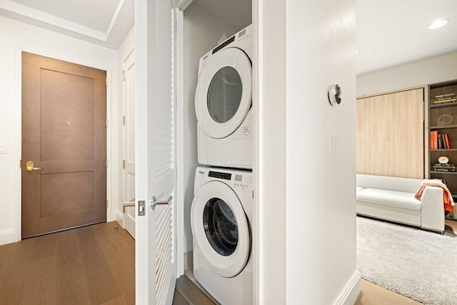 240 Devonshire St Unit 4003, Boston, MA 02110 - washroom with stacked washing machine and dryer, wood finished floors, and recessed lighting