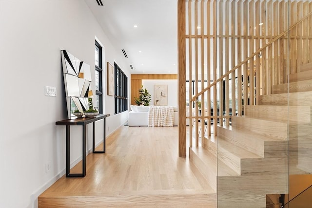 corridor with recessed lighting, baseboards, and wood finished floors