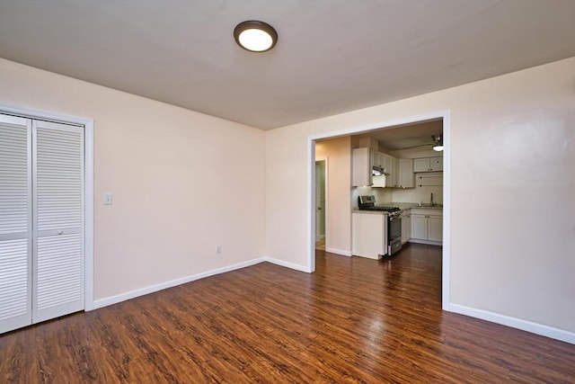 3652 N Main St Unit 4, Fall River, MA 02720 - unfurnished living room featuring baseboards and dark wood-style flooring