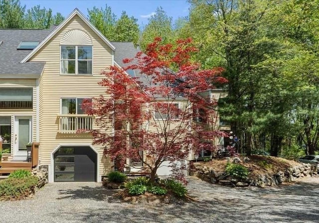 8 Deer Path Unit 8, Hudson, MA 01749 - view of side of home featuring a garage, driveway, and roof with shingles