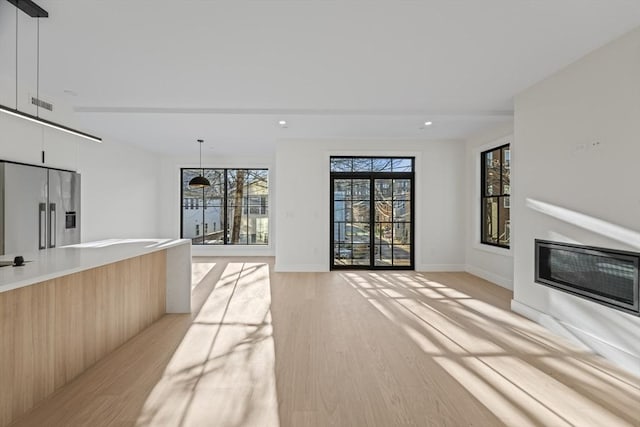 unfurnished living room featuring light hardwood / wood-style floors