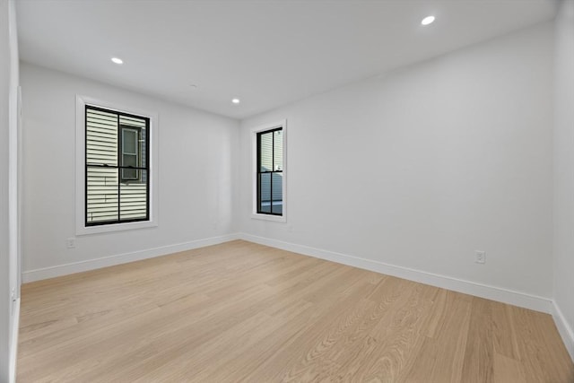 spare room with light hardwood / wood-style flooring