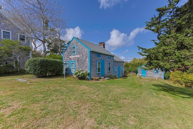 view of side of home with a yard