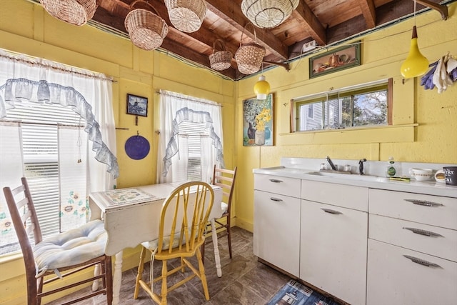 interior space featuring wooden ceiling and sink