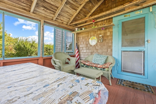 sunroom featuring vaulted ceiling with beams and wooden ceiling