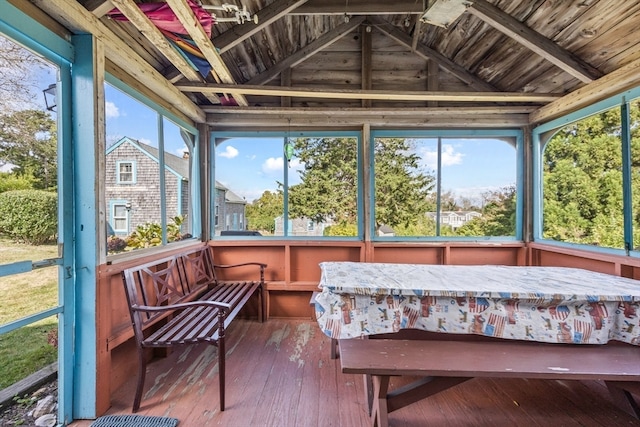 sunroom / solarium featuring lofted ceiling