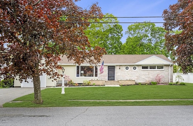 view of front facade with a garage, stone siding, driveway, and roof with shingles