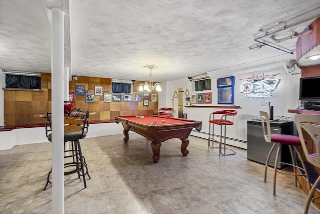 rec room featuring a baseboard heating unit, pool table, and wooden walls