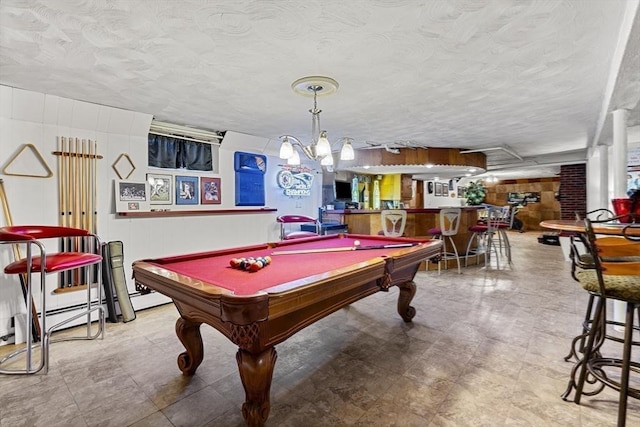 game room with billiards, a dry bar, and a textured ceiling