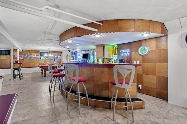 indoor dry bar featuring wood walls and billiards table