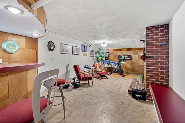 playroom with wooden walls and a dry bar