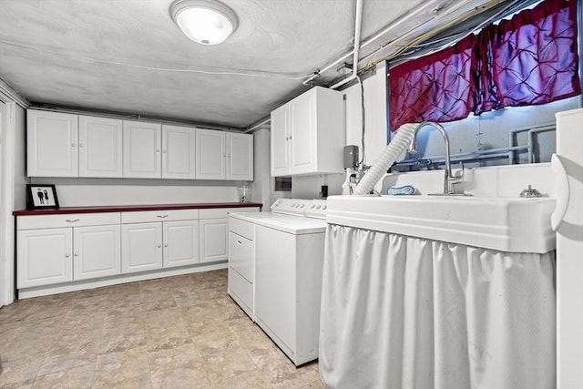 washroom featuring independent washer and dryer, cabinet space, and stone finish flooring