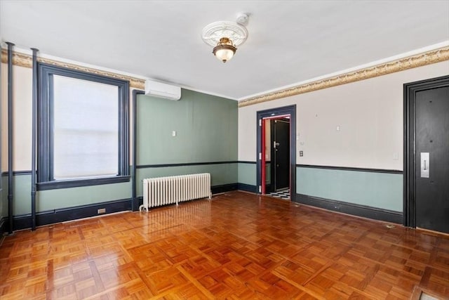 unfurnished room featuring parquet floors, radiator heating unit, and a wall mounted AC