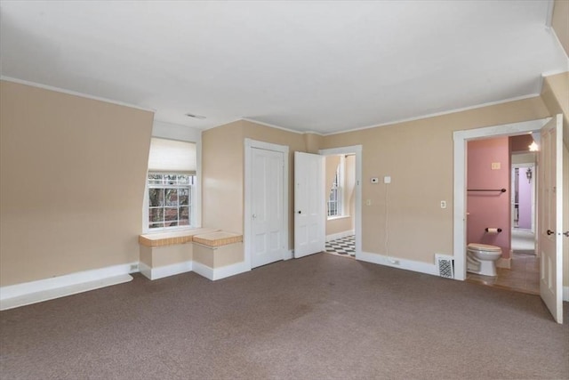 interior space featuring ornamental molding and carpet flooring