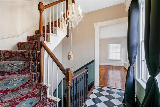 stairway with a notable chandelier