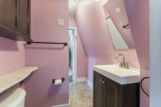 bathroom featuring tile patterned floors, vanity, and toilet