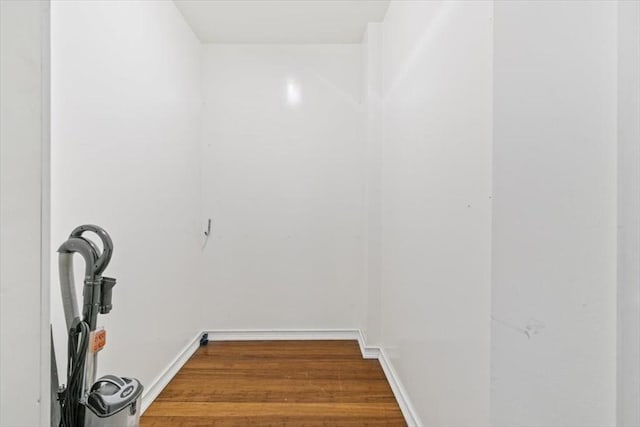 clothes washing area with hardwood / wood-style floors