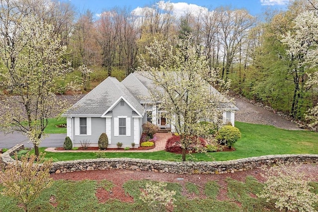 view of property exterior featuring a yard and a shingled roof