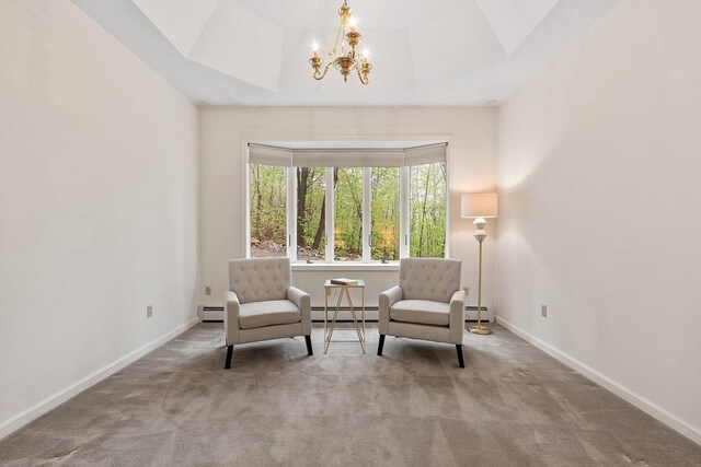 sitting room featuring a baseboard heating unit, a chandelier, carpet, baseboards, and baseboard heating