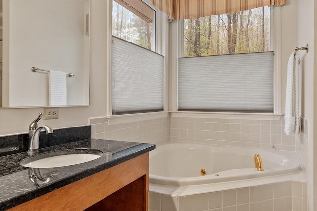 bathroom with a whirlpool tub and vanity