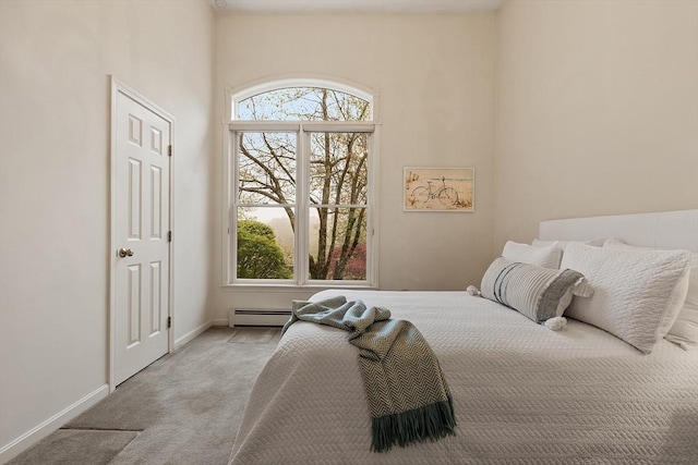 carpeted bedroom featuring baseboard heating and baseboards