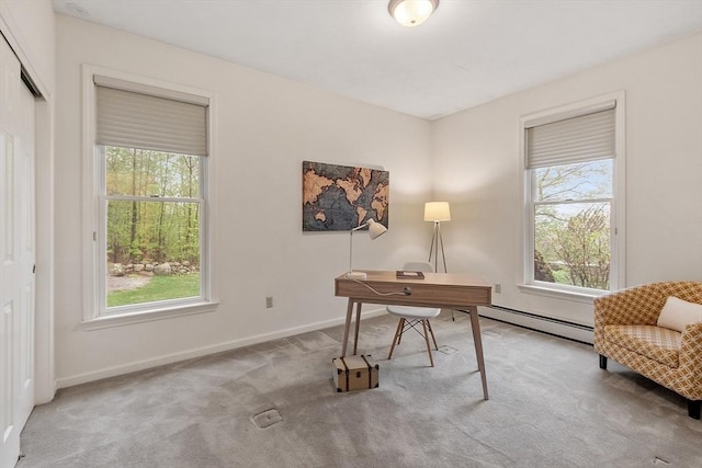 home office with a baseboard radiator, plenty of natural light, carpet flooring, and baseboards