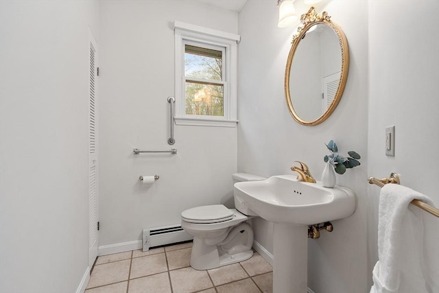 bathroom featuring a baseboard heating unit, toilet, baseboards, and tile patterned floors