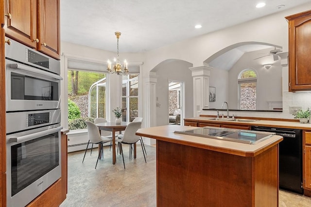 kitchen with a sink, arched walkways, black appliances, light countertops, and a kitchen island