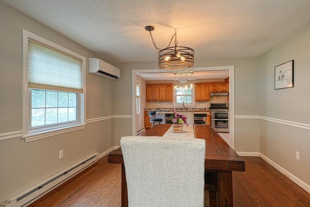 3 Alcorn Rd, Chelmsford, MA 01824 - dining room featuring a baseboard heating unit, a wall unit AC, dark wood-style flooring, a textured ceiling, and baseboards