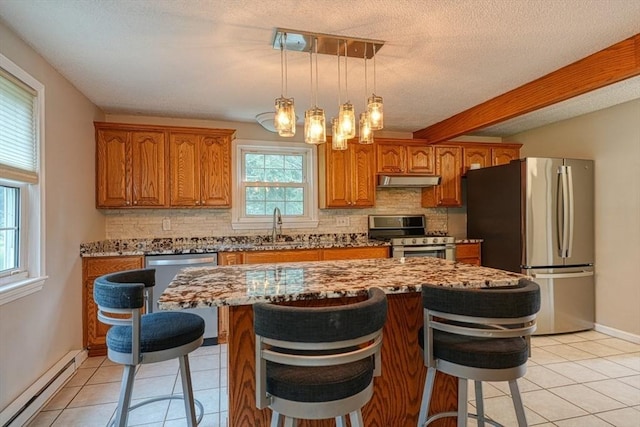 3 Alcorn Rd, Chelmsford, MA 01824 - kitchen with stainless steel appliances, a baseboard heating unit, a sink, decorative backsplash, and a textured ceiling