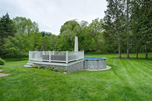 3 Alcorn Rd, Chelmsford, MA 01824 - view of grassy yard featuring a deck, an outdoor pool, and a forest view