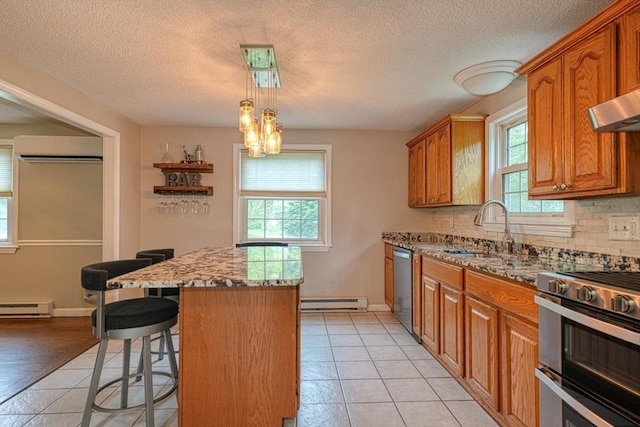 3 Alcorn Rd, Chelmsford, MA 01824 - kitchen featuring a sink, a baseboard radiator, a center island, healthy amount of natural light, and a textured ceiling