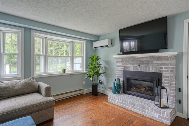 3 Alcorn Rd, Chelmsford, MA 01824 - living area with baseboard heating, a wall unit AC, a textured ceiling, healthy amount of natural light, and wood finished floors