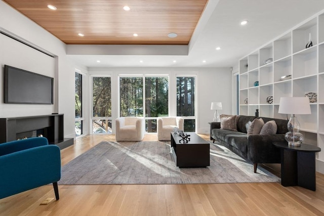 living room with light hardwood / wood-style flooring and wooden ceiling