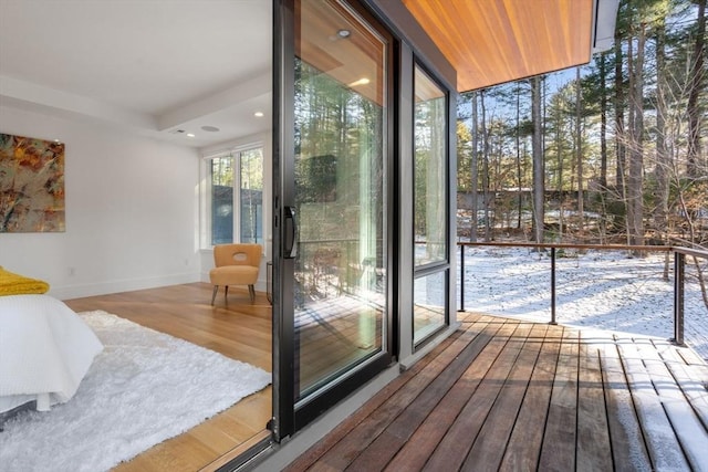 doorway to outside with hardwood / wood-style floors and expansive windows