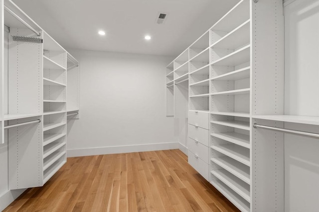 spacious closet with light hardwood / wood-style flooring