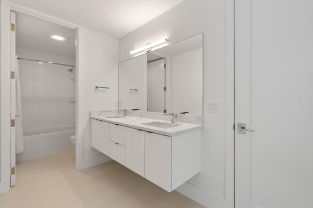 full bathroom featuring vanity, toilet, and tiled shower / bath