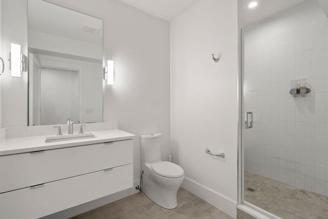 bathroom with vanity, tile patterned flooring, toilet, and walk in shower