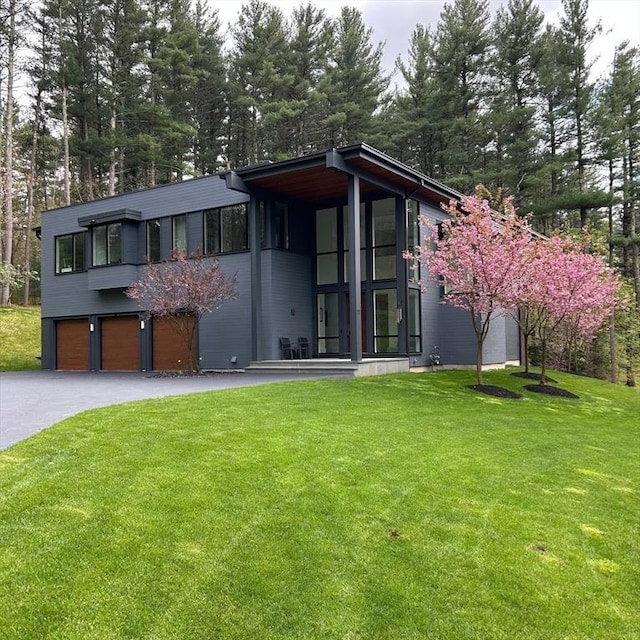 view of front of house with a garage and a front yard