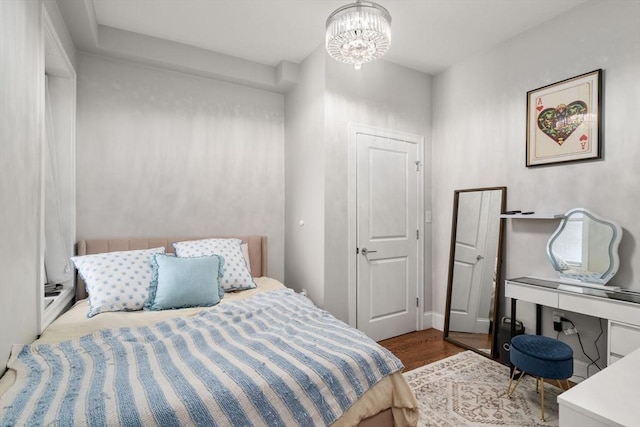 338 Meridian St Unit 2, Boston, MA 02128 - bedroom with wood finished floors and a chandelier