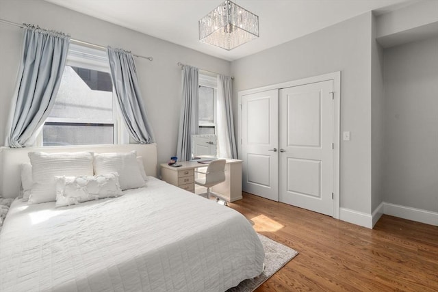 338 Meridian St Unit 2, Boston, MA 02128 - bedroom with wood finished floors, multiple windows, a chandelier, and a closet