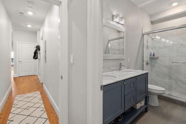 338 Meridian St Unit 2, Boston, MA 02128 - full bathroom with wood finished floors, a stall shower, and double vanity