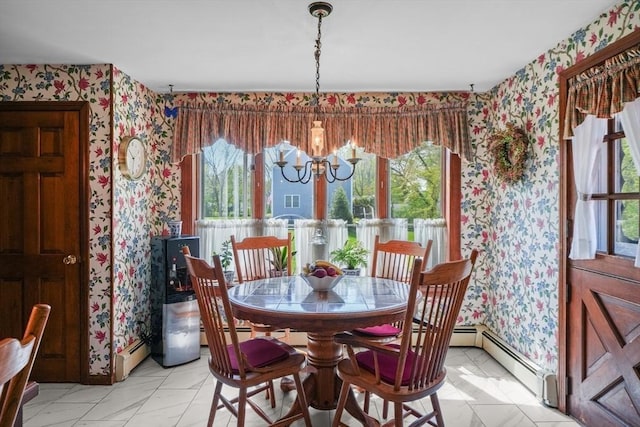 dining area with a baseboard heating unit and a chandelier