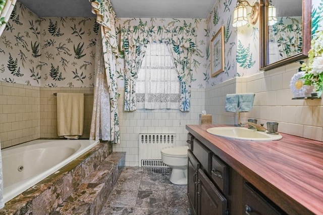 bathroom with tile walls, toilet, radiator heating unit, and vanity