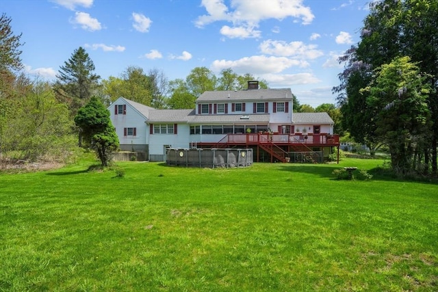 back of house with a pool side deck and a yard