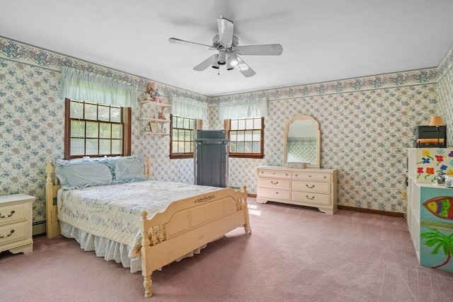 bedroom with ceiling fan, carpet, and a baseboard heating unit