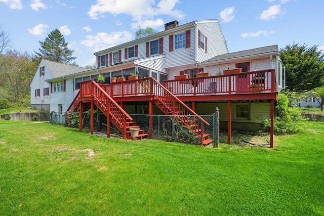 back of property featuring a lawn and a deck